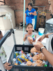 Child receiving food at soup kitchen
